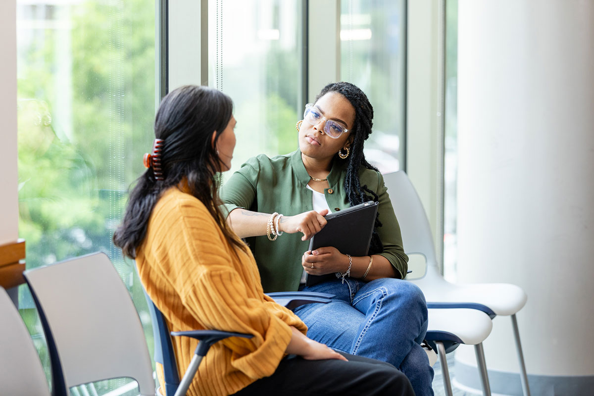 Unrecognizable woman speaking to her female counselor