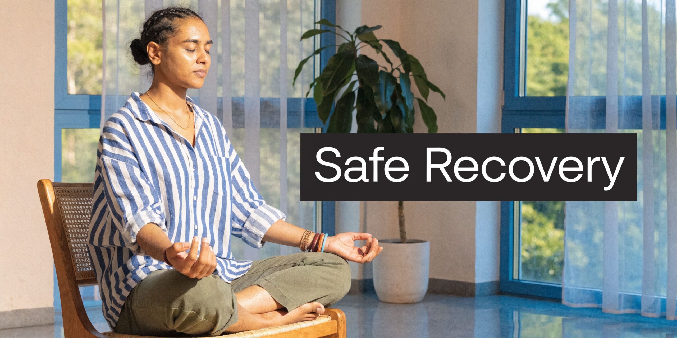 A woman meditating on a wooden chair near a window with the words Safe Recovery overlaid.