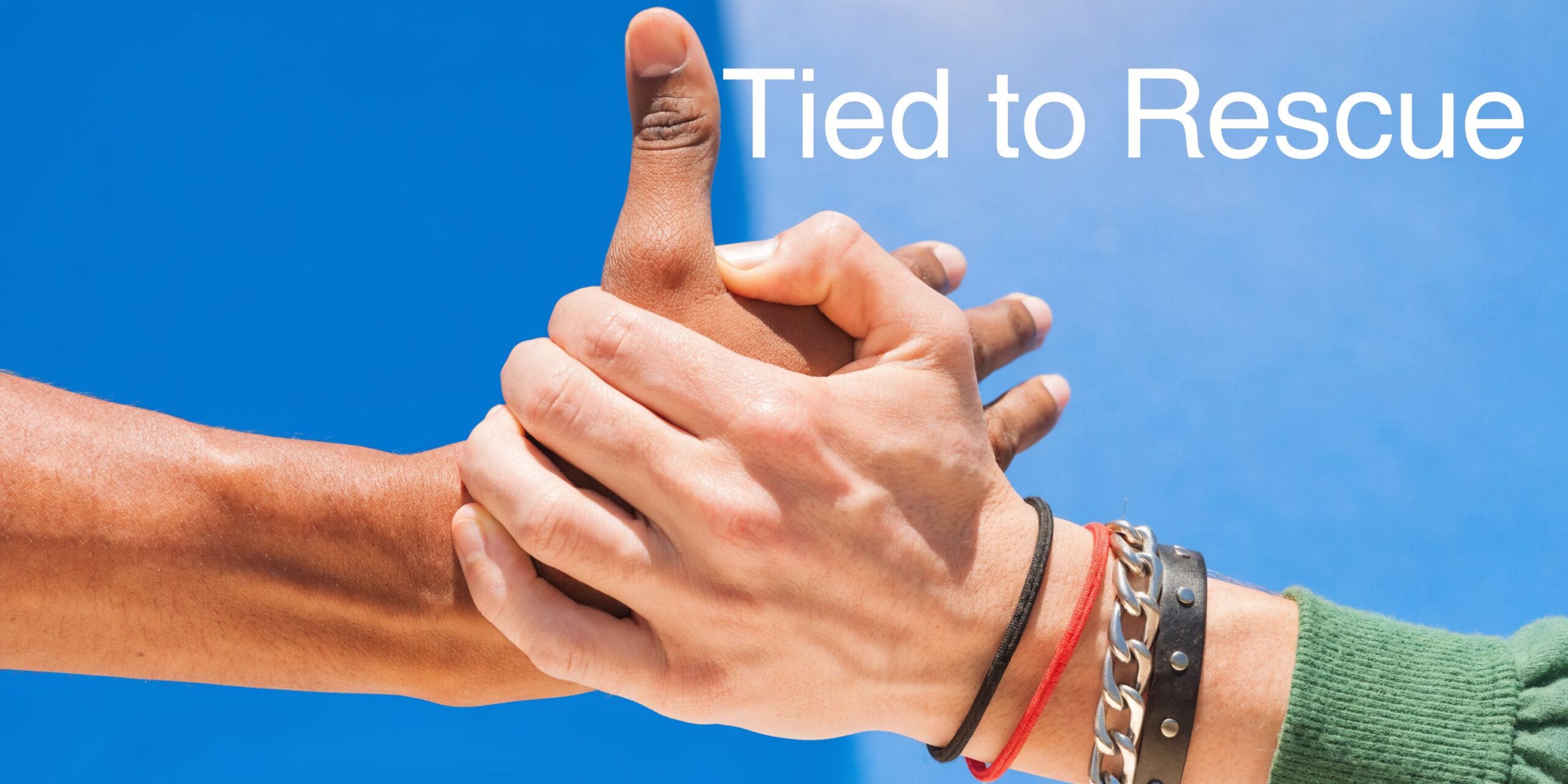 A close-up of two hands holding each other firmly against a bright blue sky background.