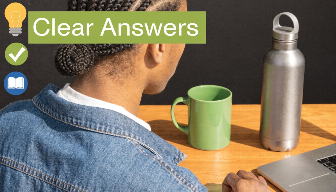 A person sitting at a desk with a laptop, a green mug, and a metallic water bottle.