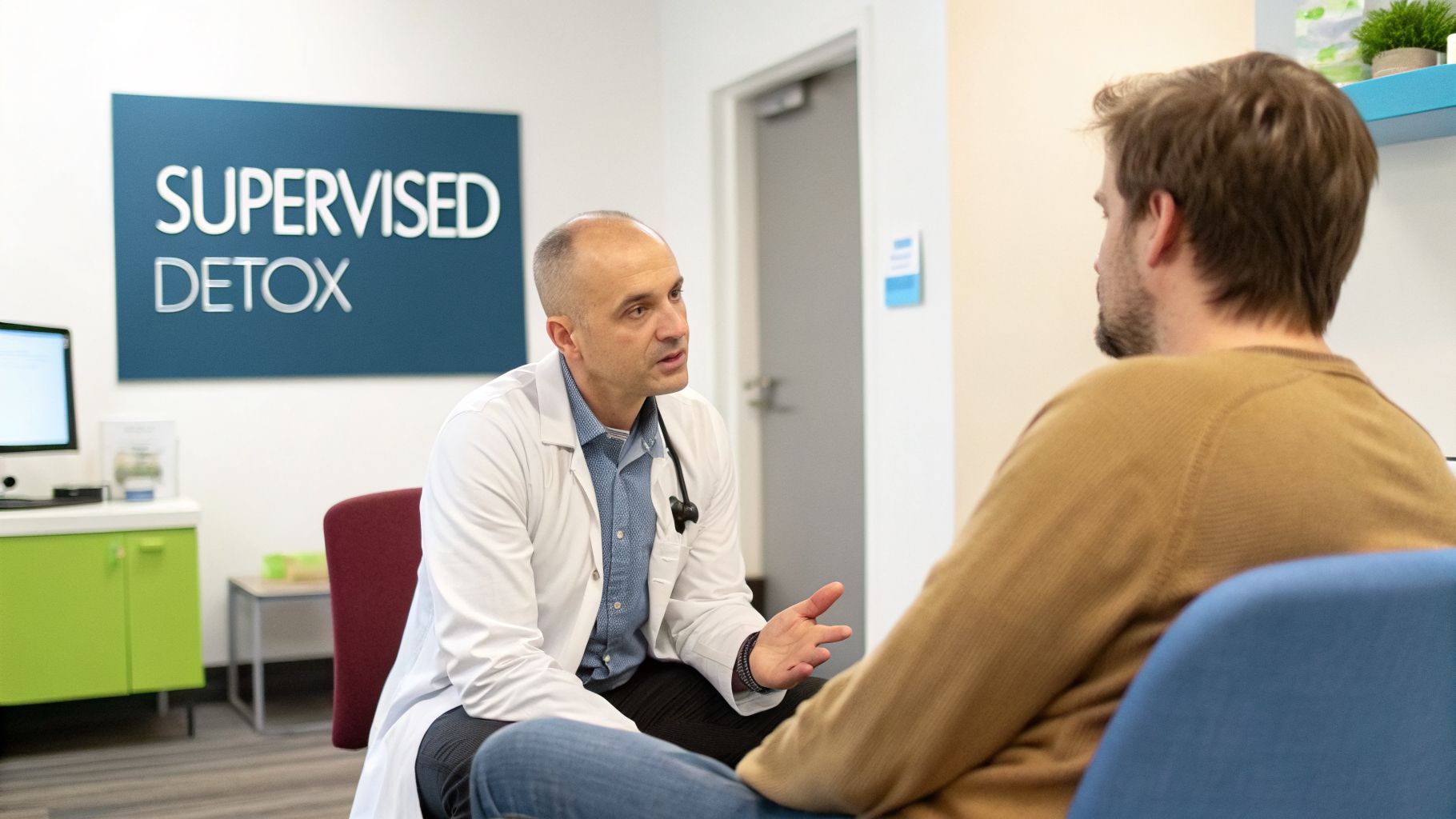 A doctor in a white coat discusses supervised detox with a male patient.