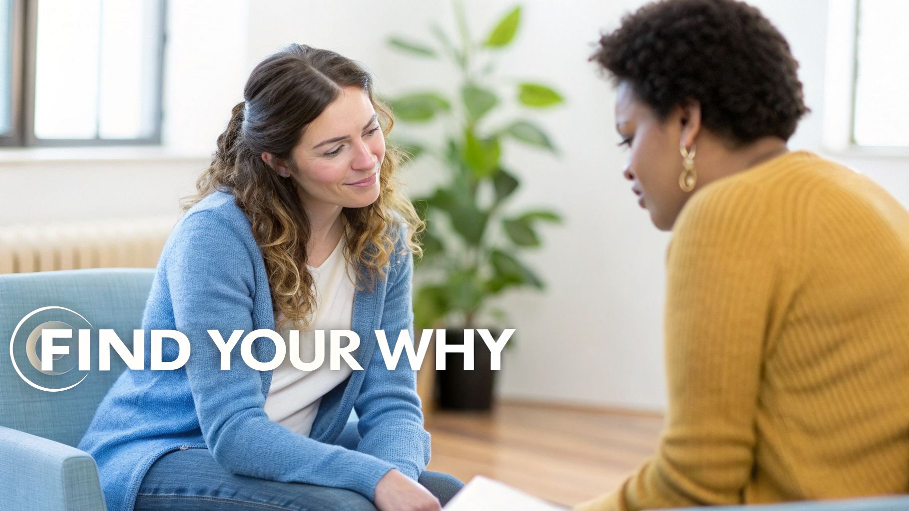 Two women engaged in a supportive conversation, one smiling, in a counseling session setting.