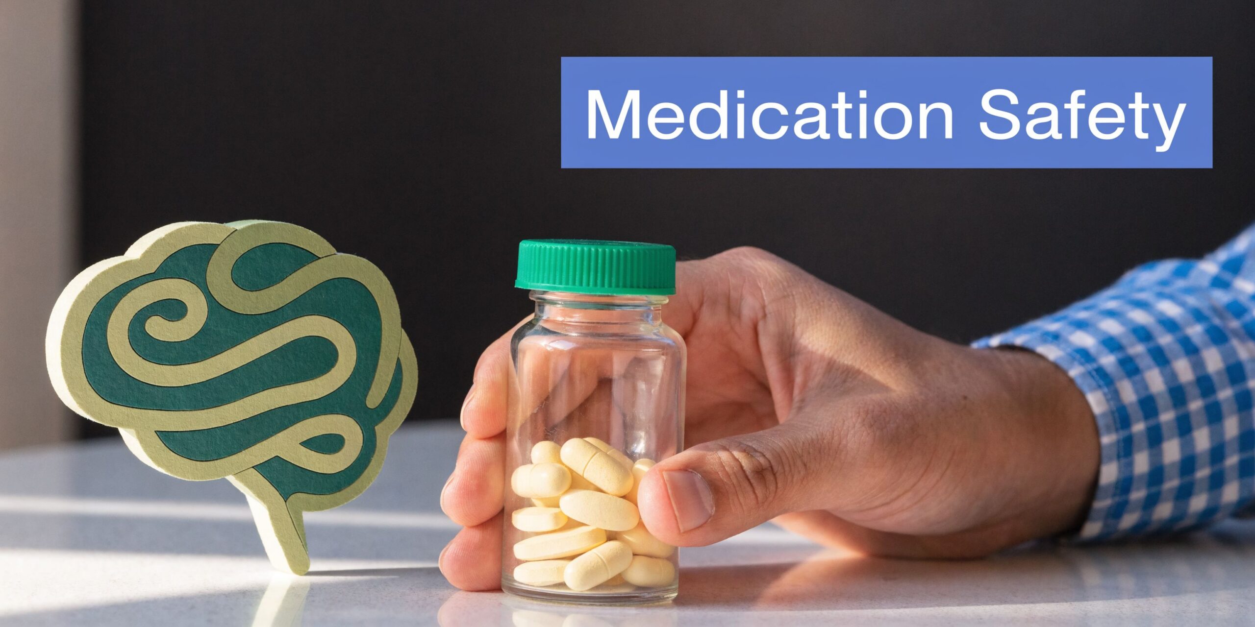 A hand holding a pill bottle next to a brain model representing ADHD medication safety awareness.