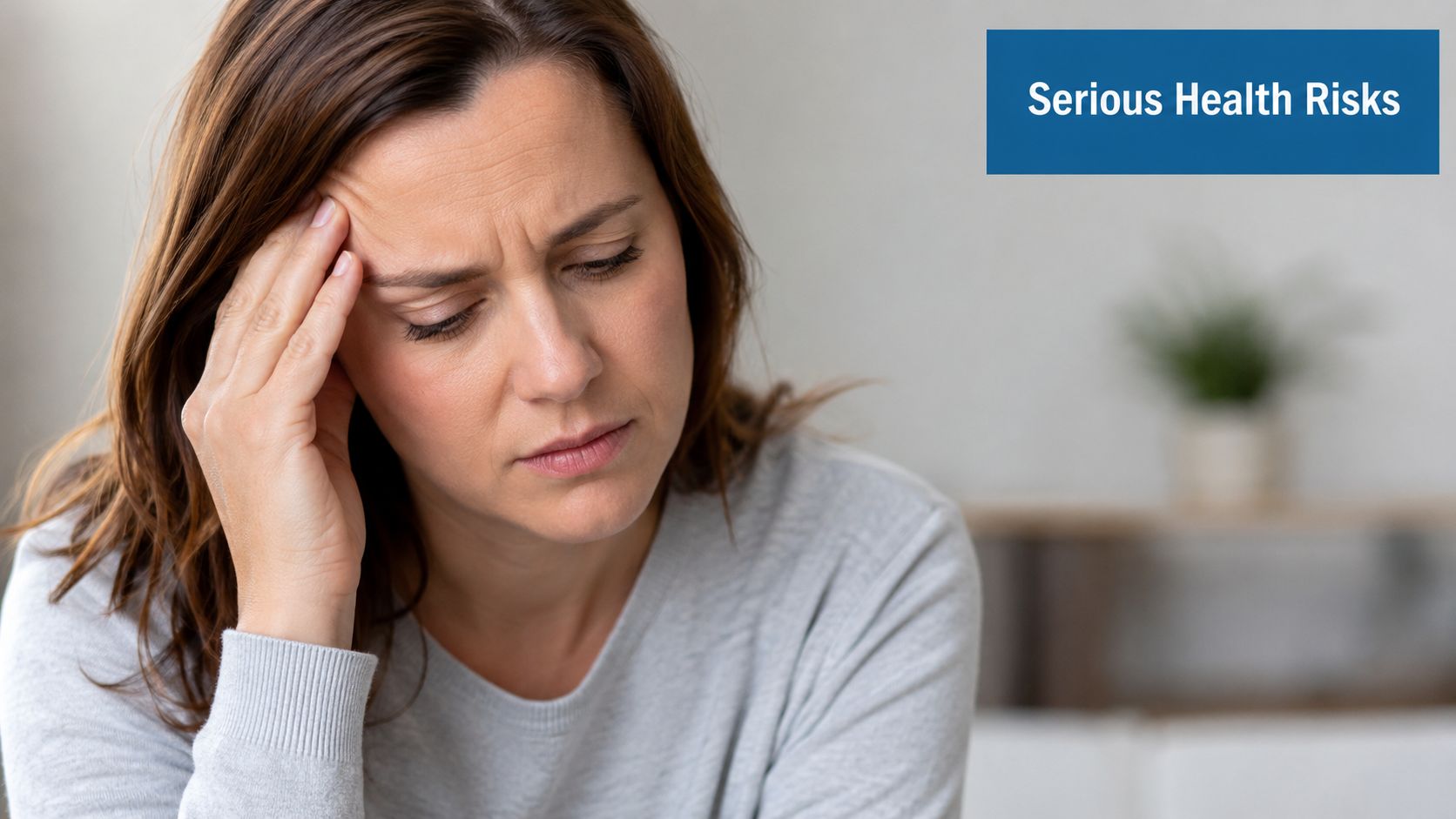 A distressed woman holding her head in pain, representing the concept of potential serious health risks.