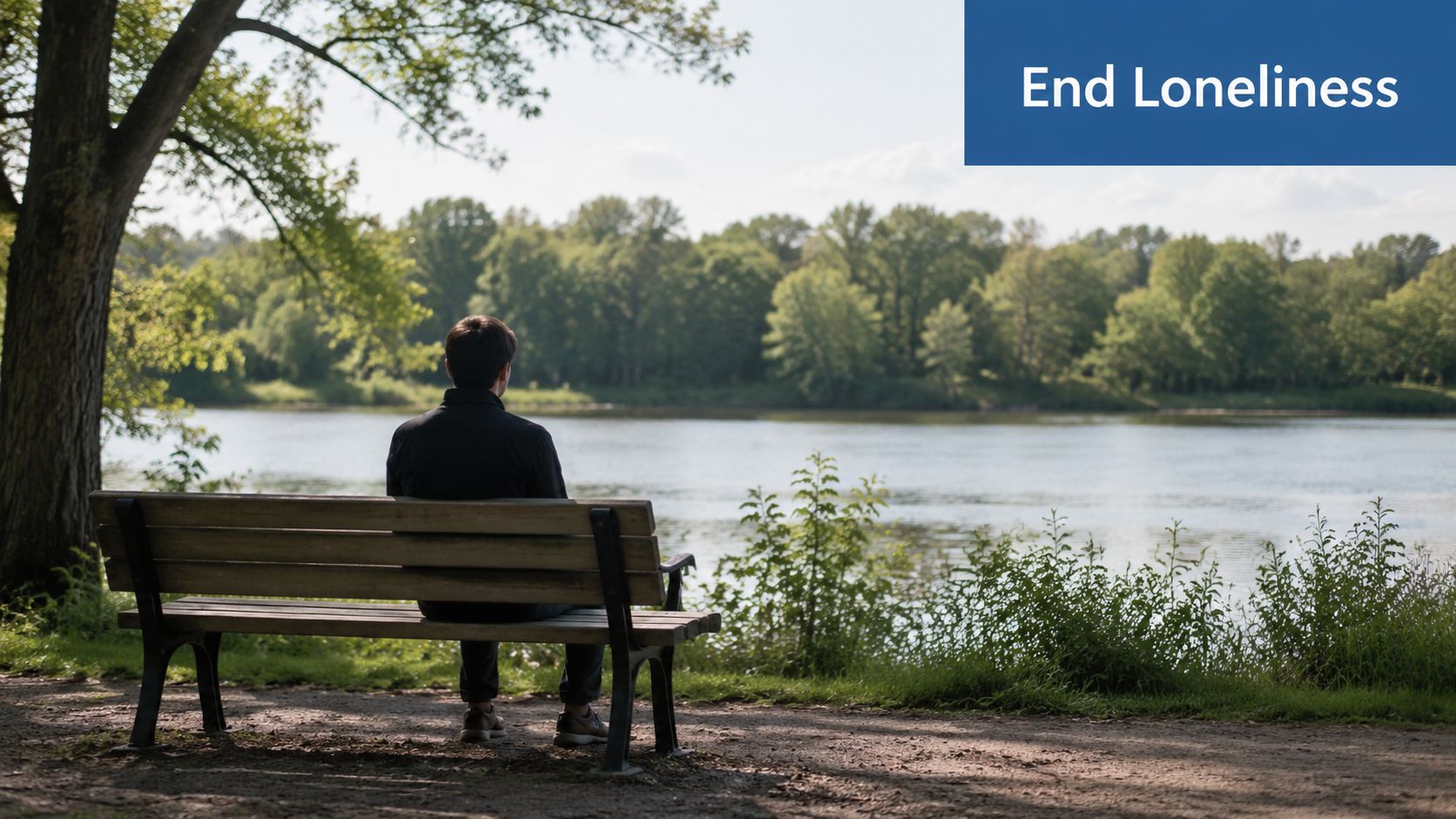 A person sitting alone on a park bench by a calm river, reflecting on social connection.