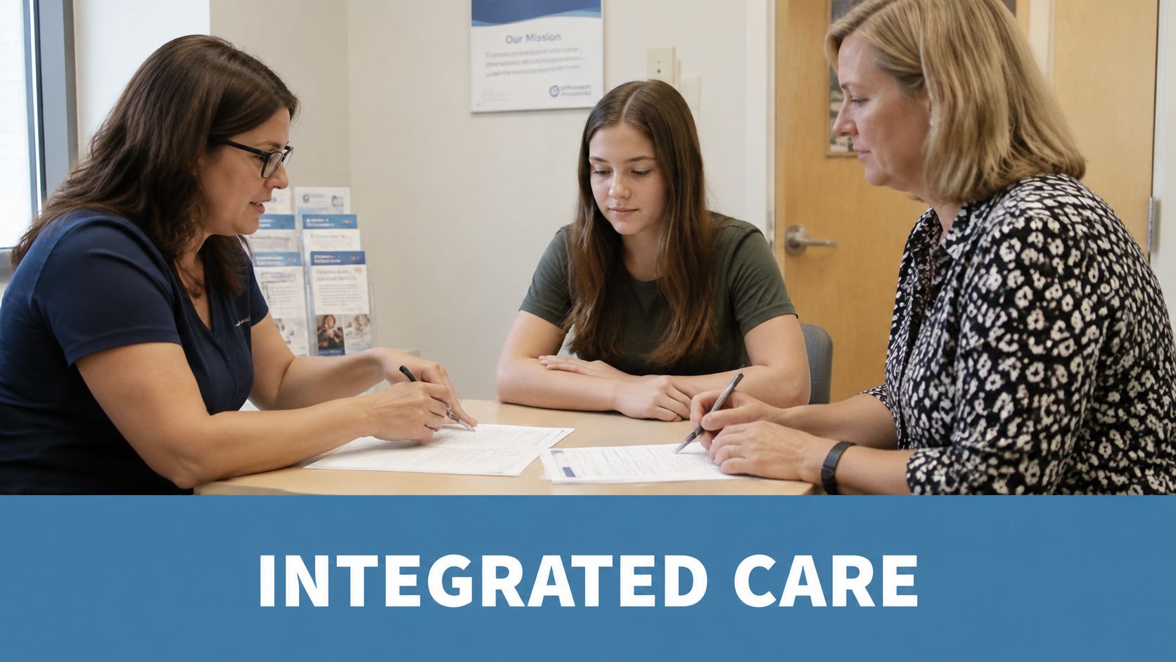 A professional therapist reviews educational support documents with a student and her parent at a desk.